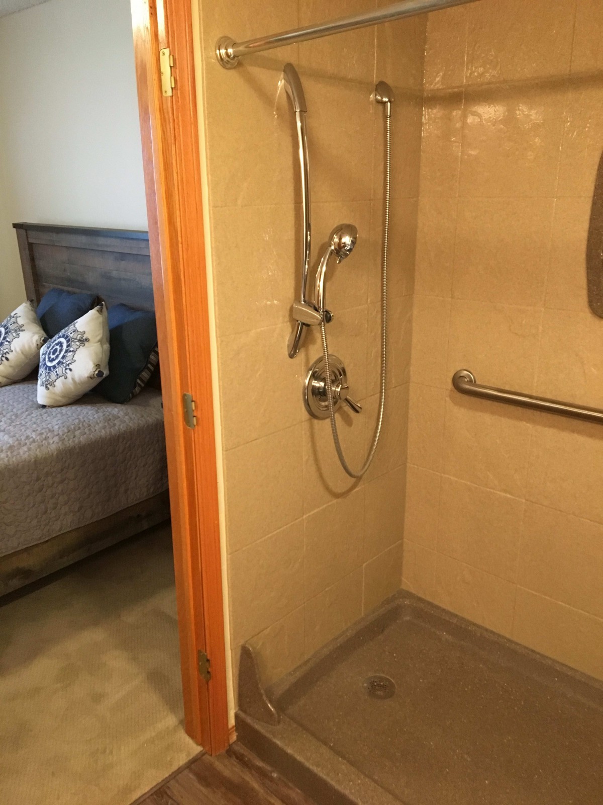 An accessible shower adjacent to a bedroom.