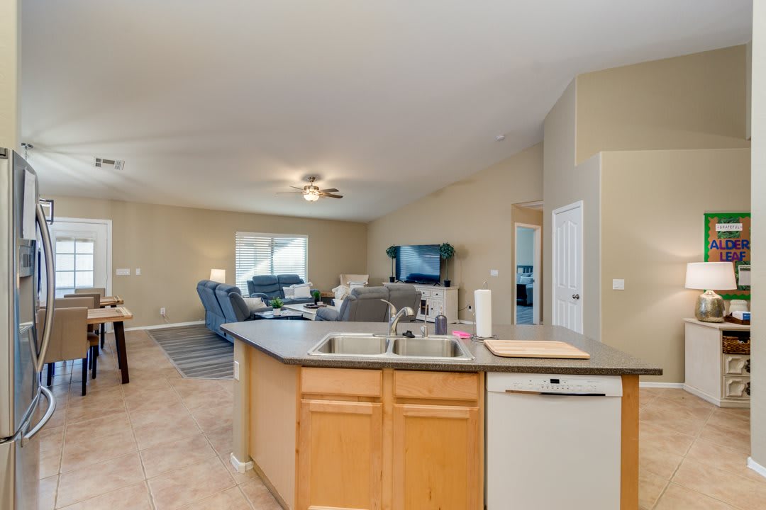 An open-concept kitchen and living room with modern appliances and comfortable seating.