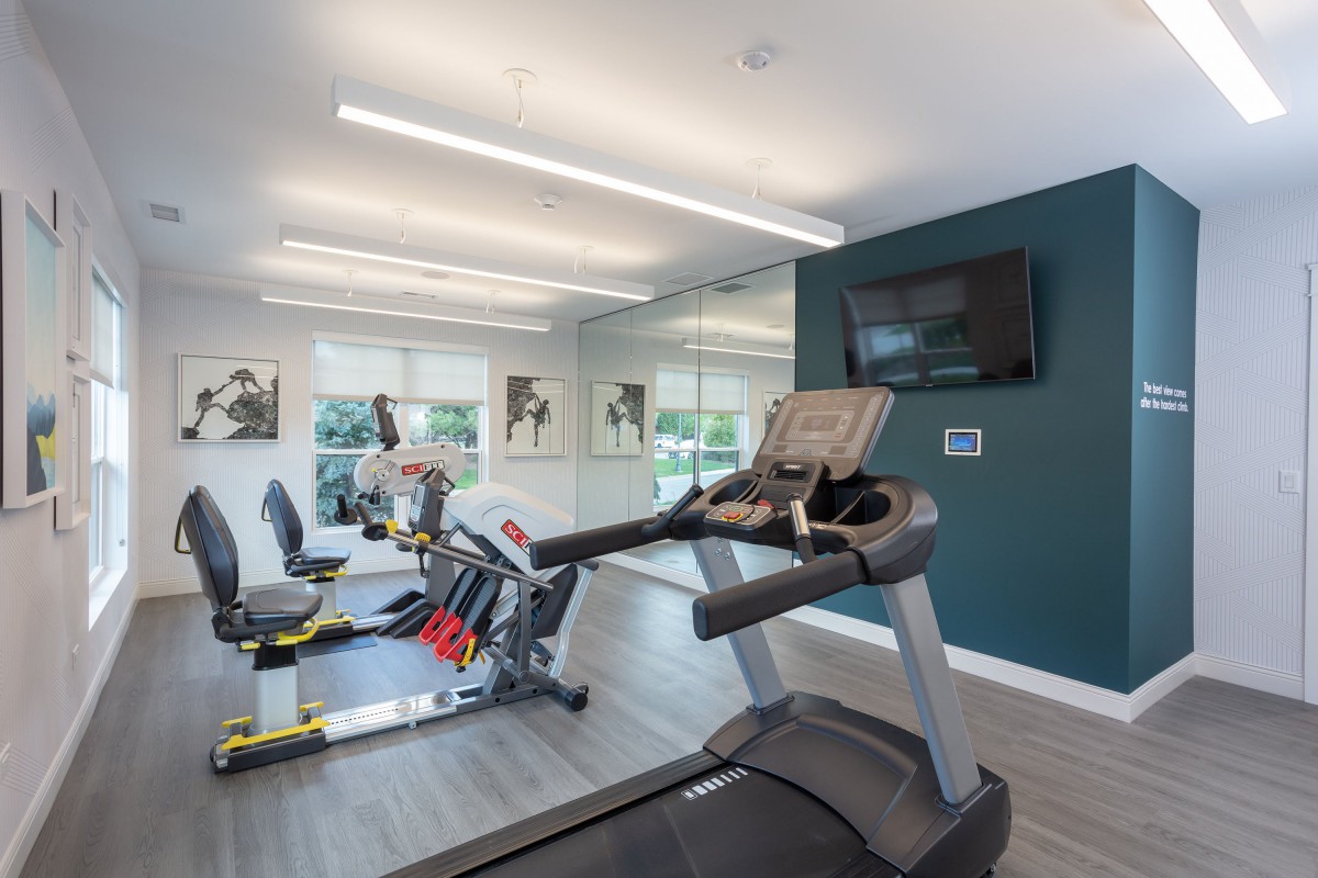 A modern fitness center equipped with treadmills and exercise bikes.