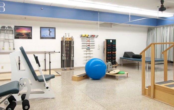 A physical therapy room equipped with exercise tools and rehabilitation equipment.