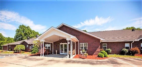 A single-story brick residential building with a covered entrance.