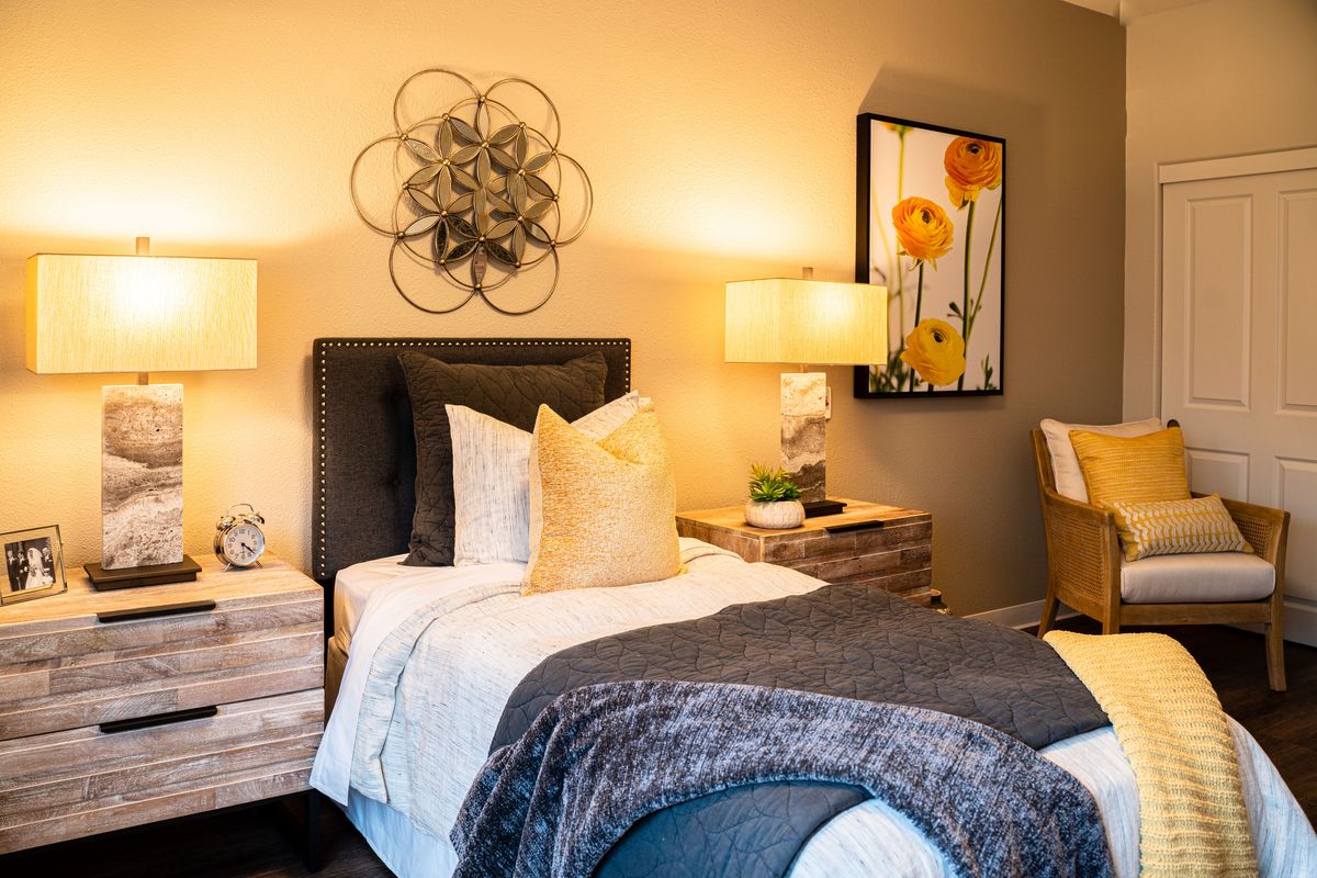 A cozy modern bedroom with stylish decor and soft lighting.