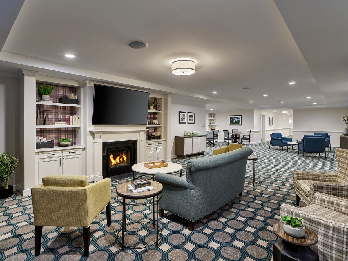 A modern living room with comfortable seating, a fireplace, and a television.