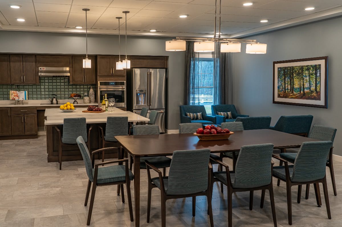 A modern kitchen and dining area with sleek furniture and stylish lighting.