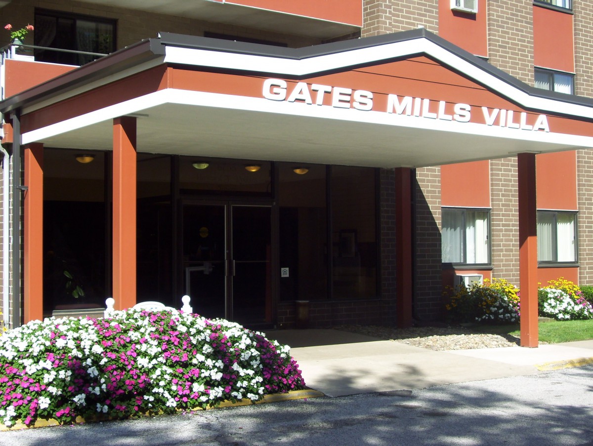 Entrance to Gates Mills Village with floral landscaping.