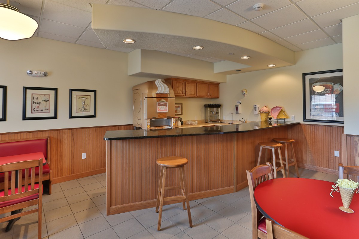 A cozy kitchen area with a wooden counter and bar stool seating.