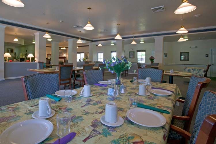 A spacious dining room with tables neatly set for a meal.