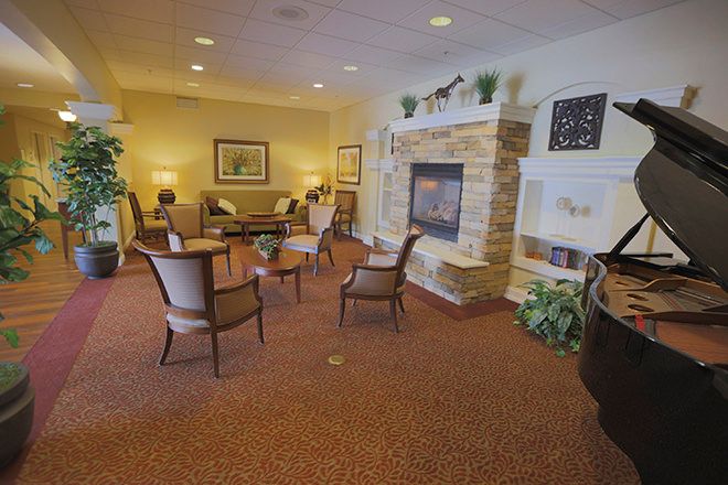 A cozy living room with a fireplace and comfortable seating.