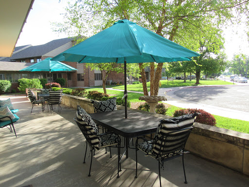 A cozy outdoor seating area with teal umbrellas, perfect for enjoying a sunny day.