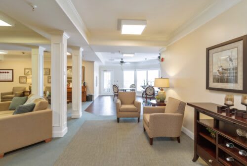 A spacious living room with comfortable seating and warm lighting.