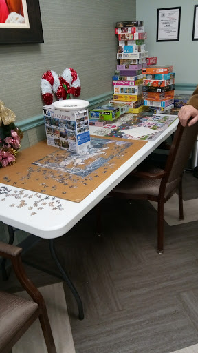 A table set up for puzzle assembly, featuring various puzzle boxes and pieces scattered around.