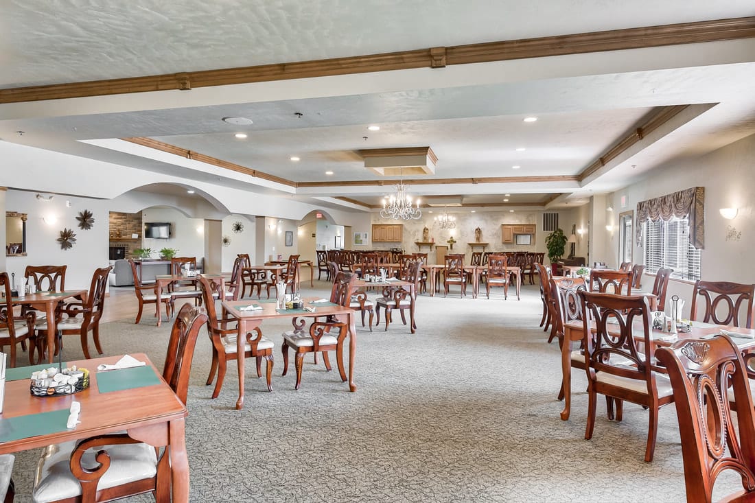 Spacious dining area with elegant wooden furniture and soft lighting.