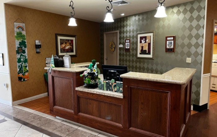 A welcoming reception area with a wooden desk and ambient lighting.