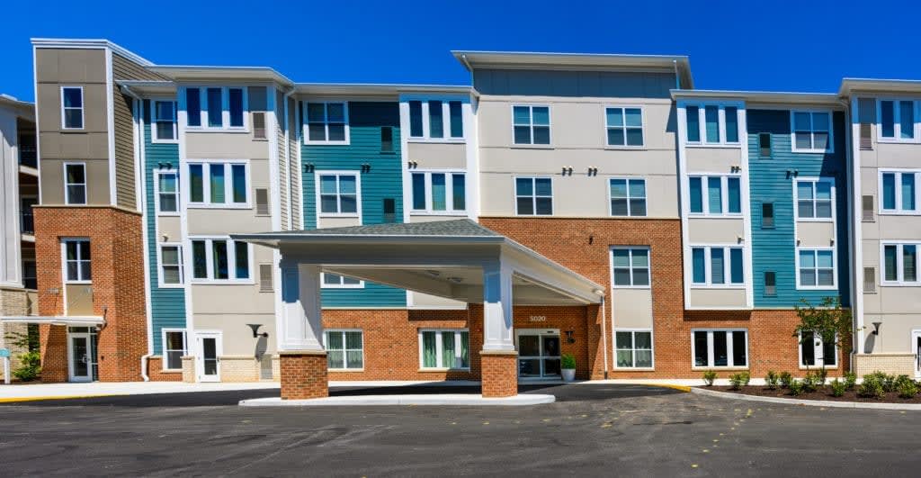 A modern apartment complex with a mix of materials and colors in its facade.