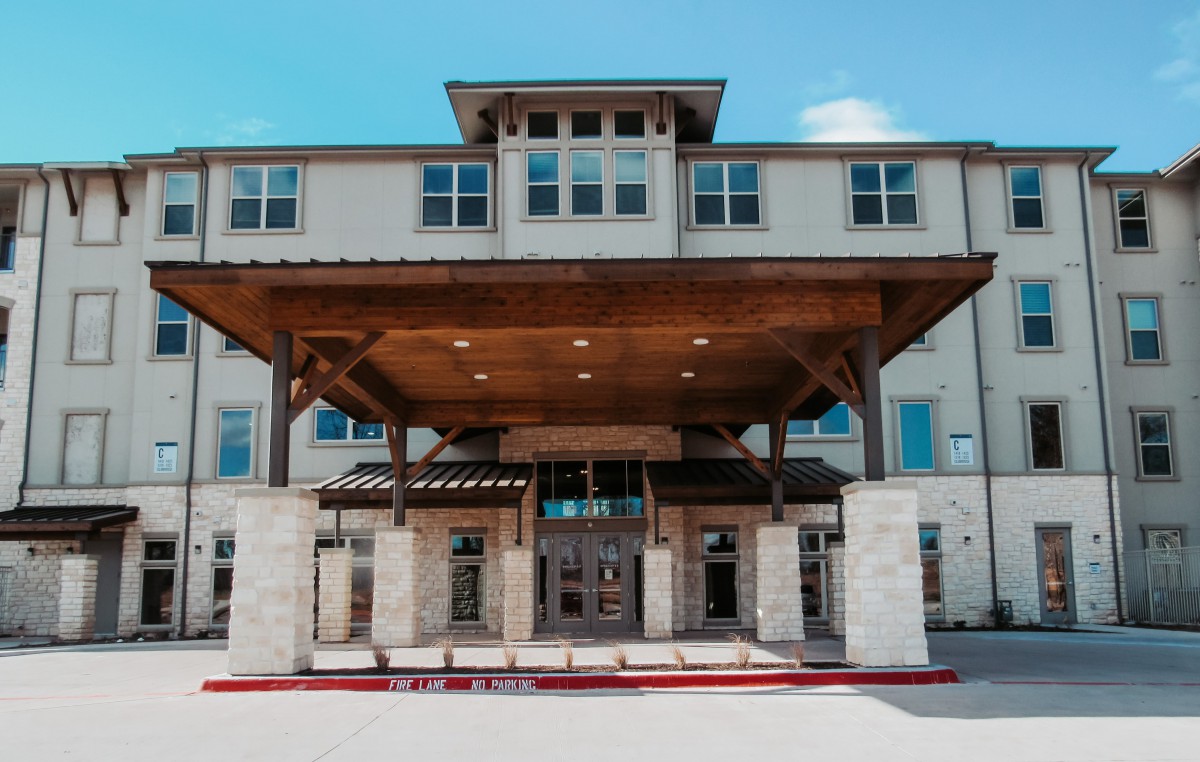 Front view of a modern commercial building with a covered entrance.