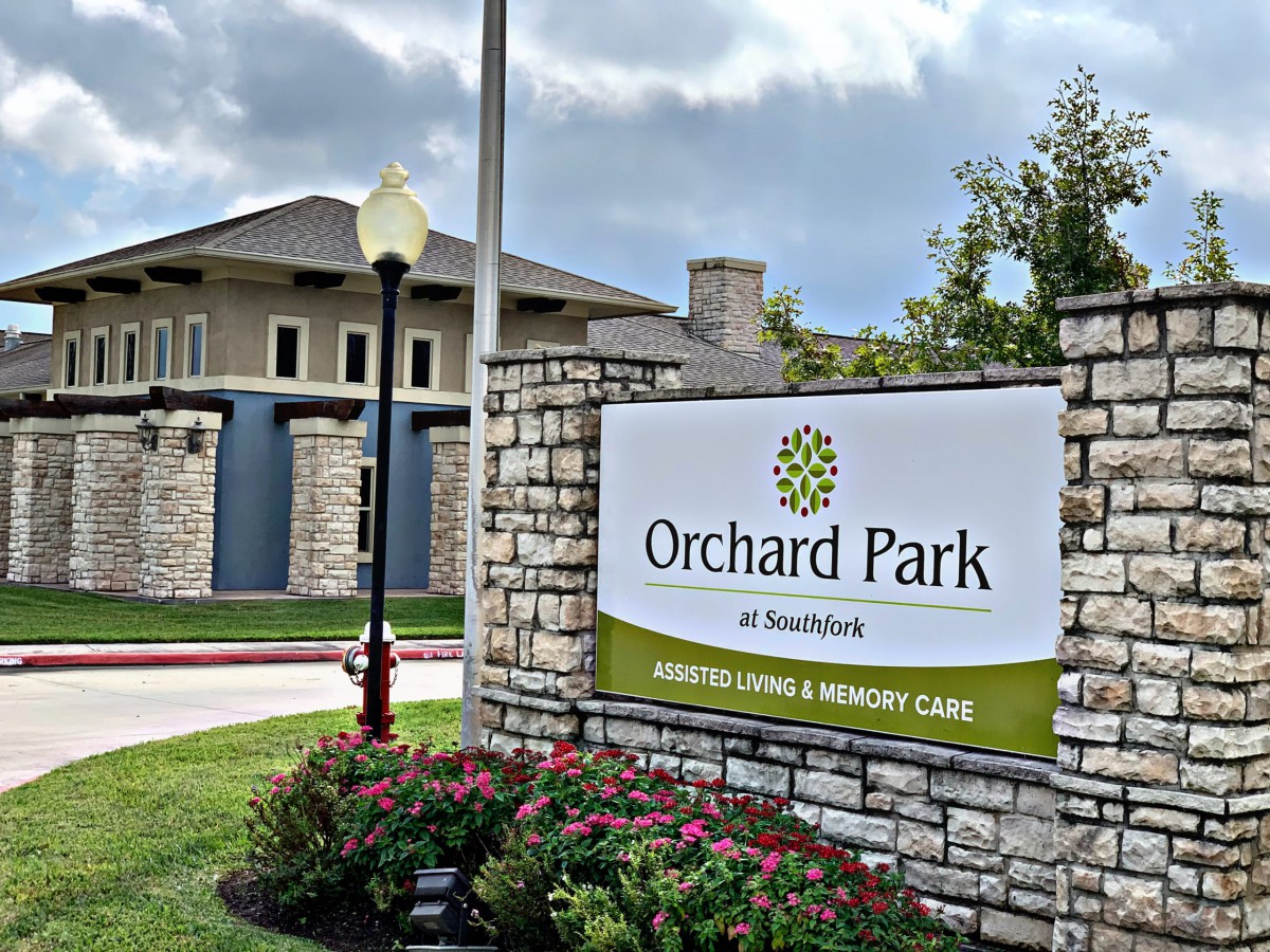 Sign for Orchard Park, a senior living and memory care community.