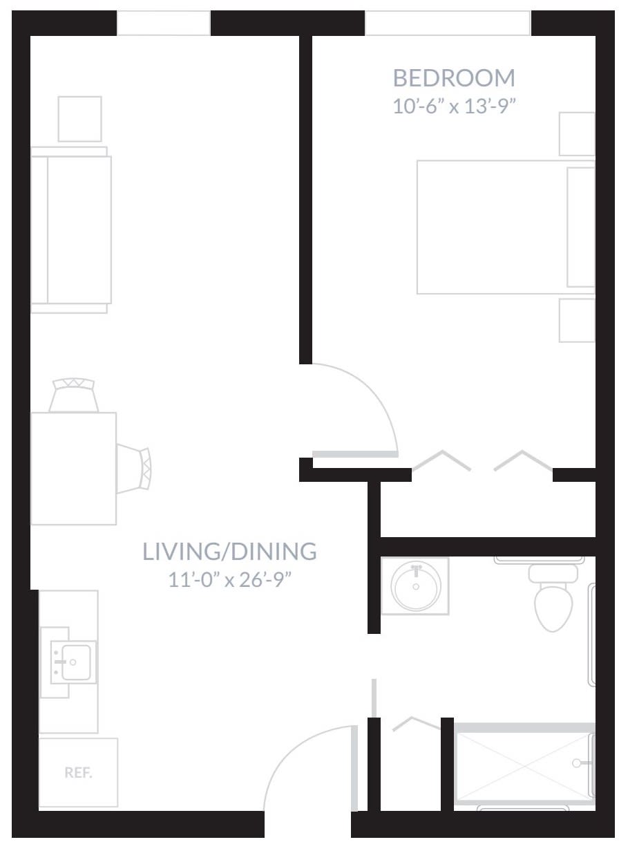 A floor plan showing the layout of an apartment with a living/dining area, bedroom, and bathroom.