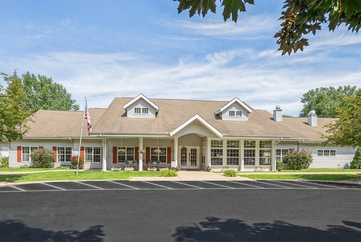 Suburban residential building with a well-maintained lawn and clear blue sky.