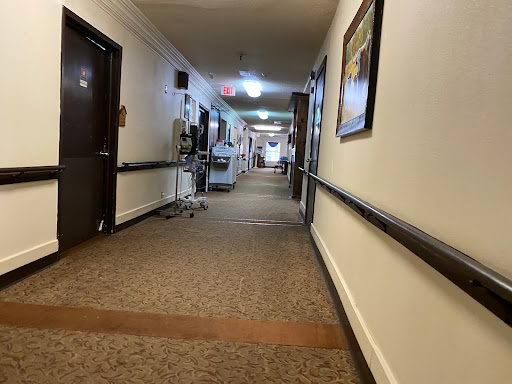 A long, well-lit hallway in a healthcare facility.