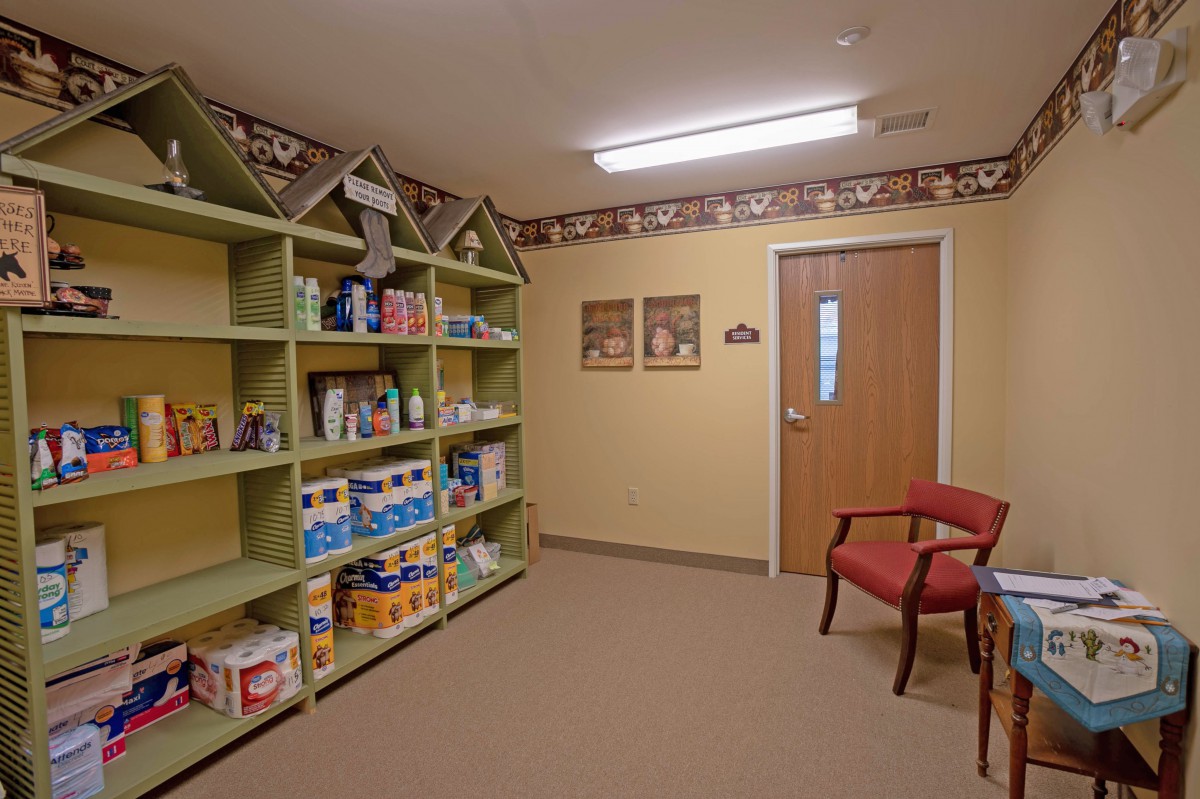 A veterinary clinic waiting room with shelves stocked with pet supplies and animal-themed decor.