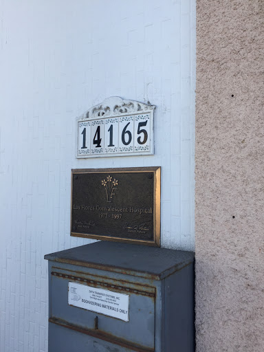 A decorative house number and mailbox displayed on the wall, indicating the address 14165.