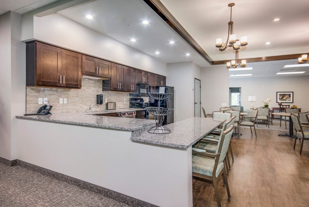 A spacious and modern kitchen with a large countertop and elegant lighting.