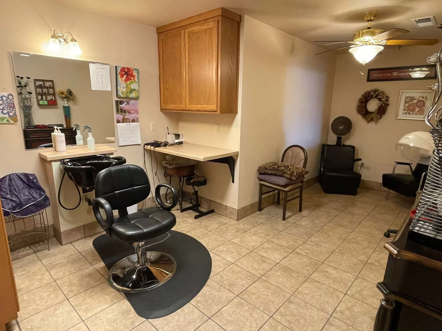 A cozy salon with a barber chair, mirror, and waiting area.