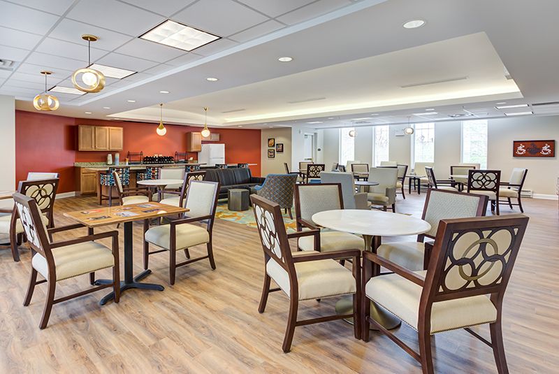 A modern dining area with neatly arranged tables and chairs, featuring an open layout and contemporary design.