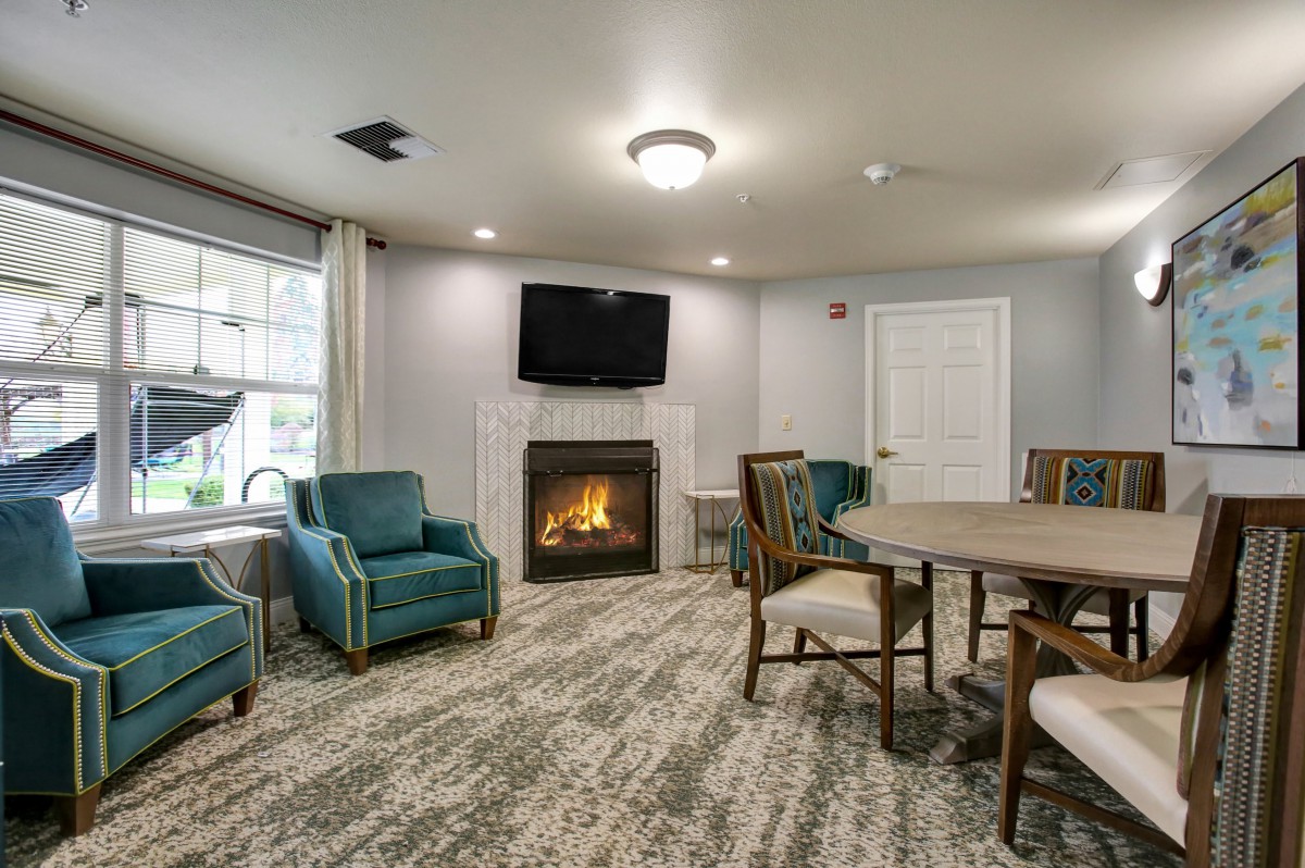 A cozy living room with a fireplace, television, and seating area.