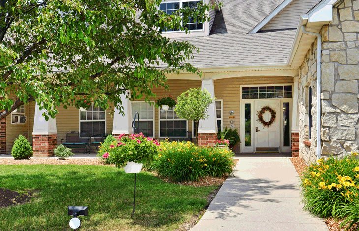 A charming suburban house with a well-maintained garden and welcoming front porch.
