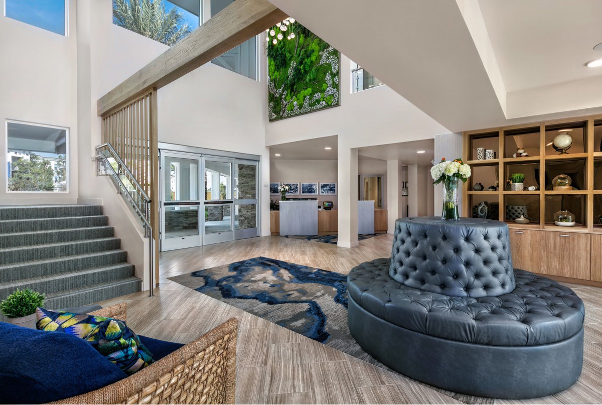 Modern lobby with stylish furniture and a staircase.