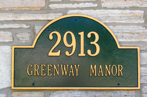 Address sign for Greenway Manor displaying the house number 2913.