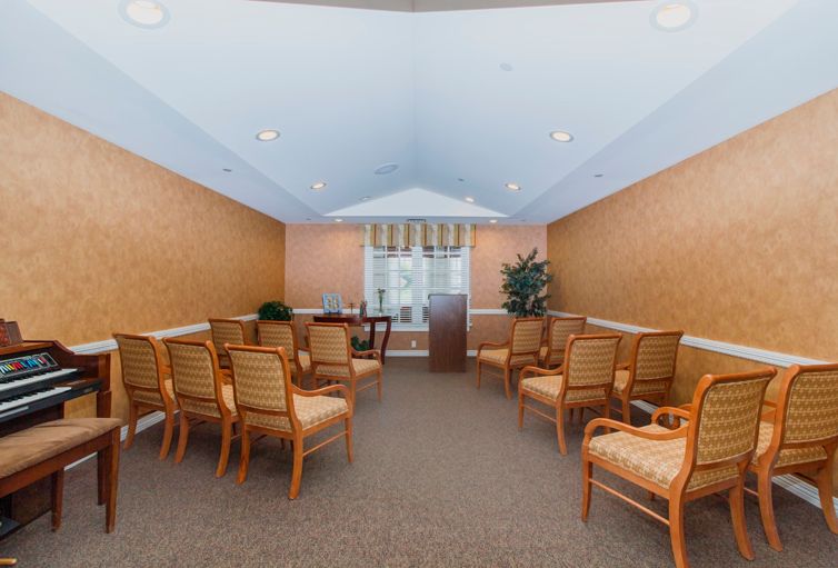 A small conference room with chairs arranged facing a podium.