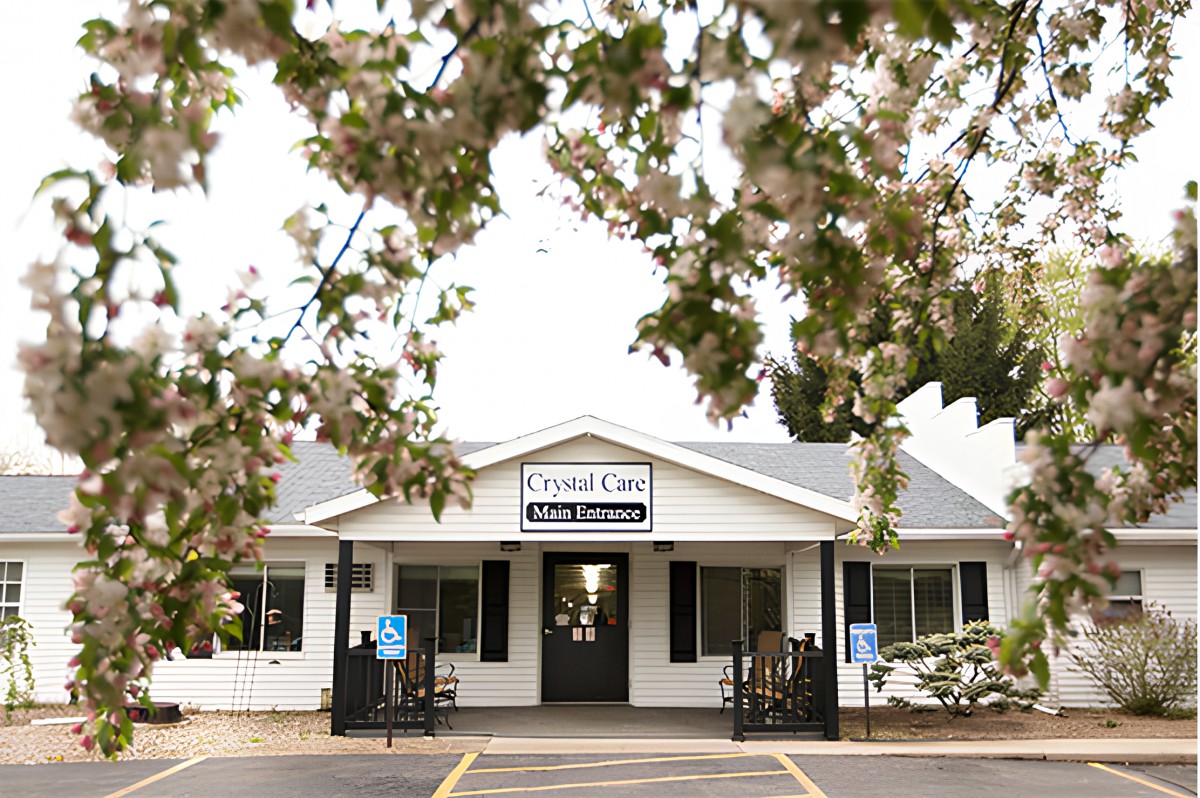 A small clinic building surrounded by blossoming trees.