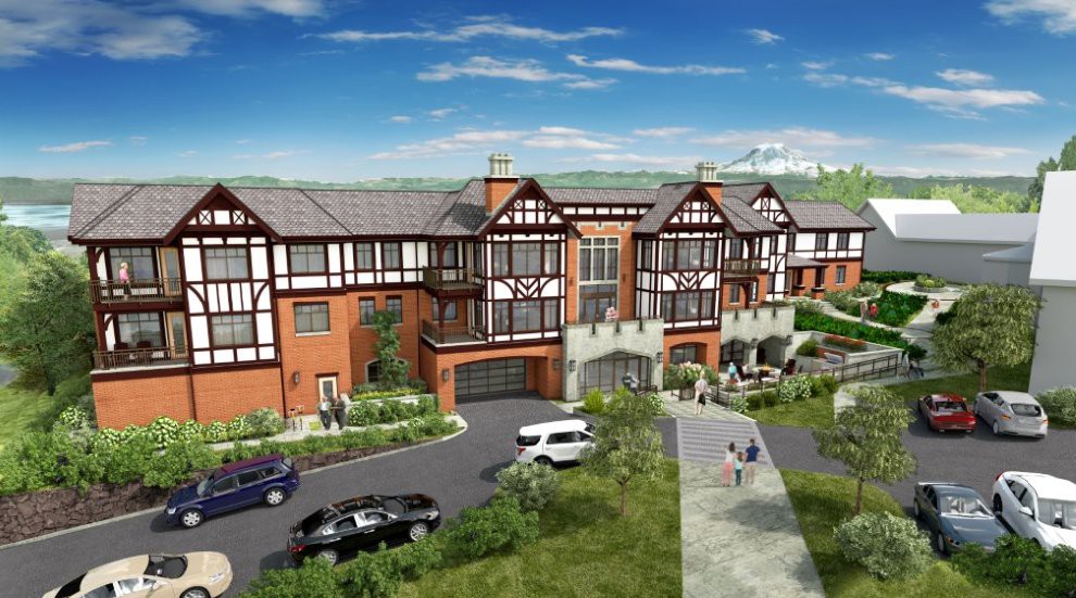 A Tudor-style residential building surrounded by landscaping, with parked cars and people walking along a pathway under a clear blue sky.