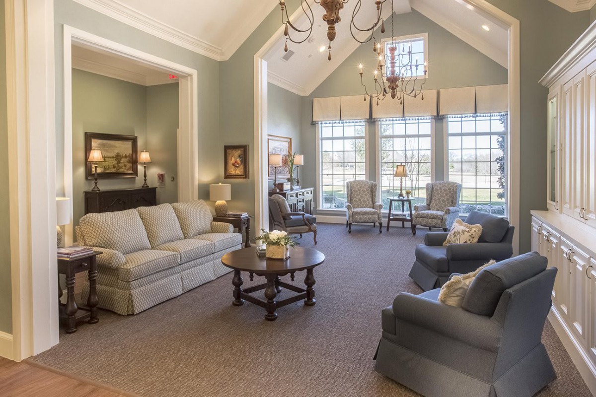 A spacious and elegantly decorated living room with comfortable seating and plenty of natural light.