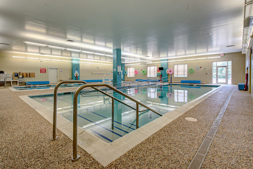 A spacious indoor swimming pool with a clean and inviting atmosphere, perfect for relaxation and exercise.