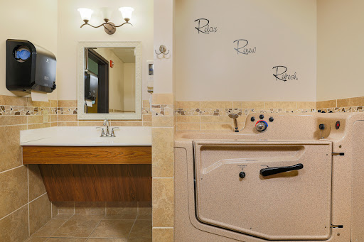 A modern bathroom featuring a stylish vanity with a mirror, decorative tiles, and a bathtub.