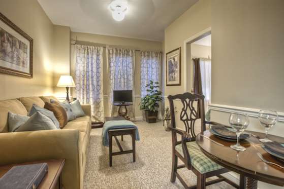 A cozy and elegantly decorated living room with classic furniture.
