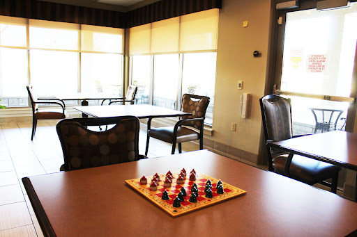 A chess set ready for a game in a bright, inviting community space.