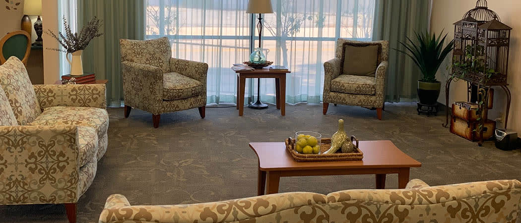 A cozy living room setup with two armchairs, a coffee table, and soft lighting.