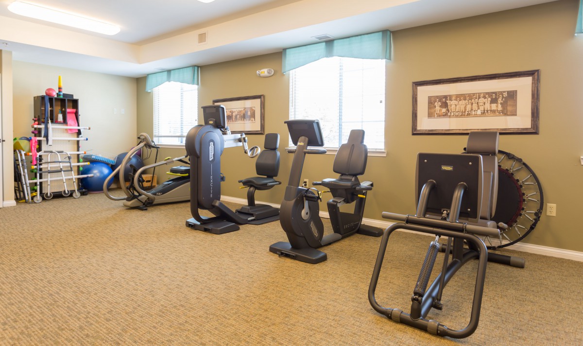 A well-equipped indoor gym with various exercise machines.