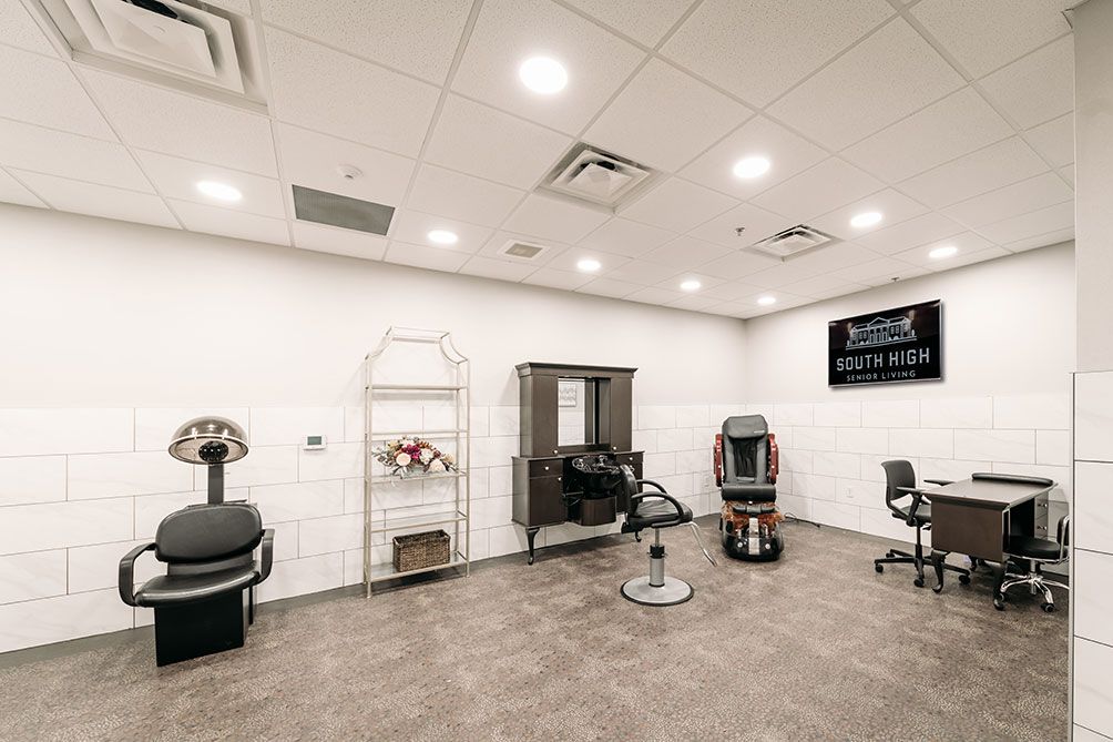 A modern salon interior with seating and equipment.