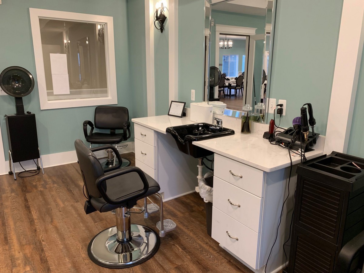 A well-equipped hair salon station with styling chairs and mirrors.