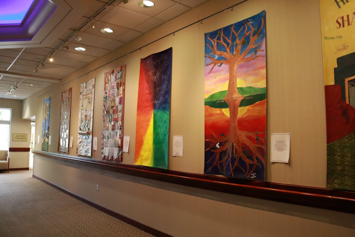 A vibrant art gallery display showcasing a variety of colorful paintings.