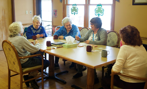 Seniors engaging in a lively discussion at a community center.
