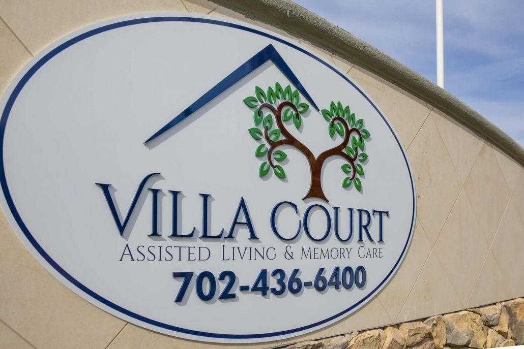 Sign for Villa Court Assisted Living & Memory Care with contact number displayed.
