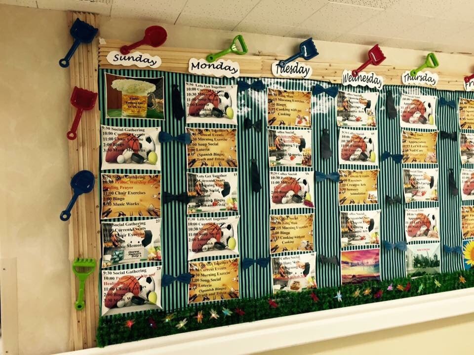 A classroom bulletin board displaying weekly lesson plans with colorful decorations.