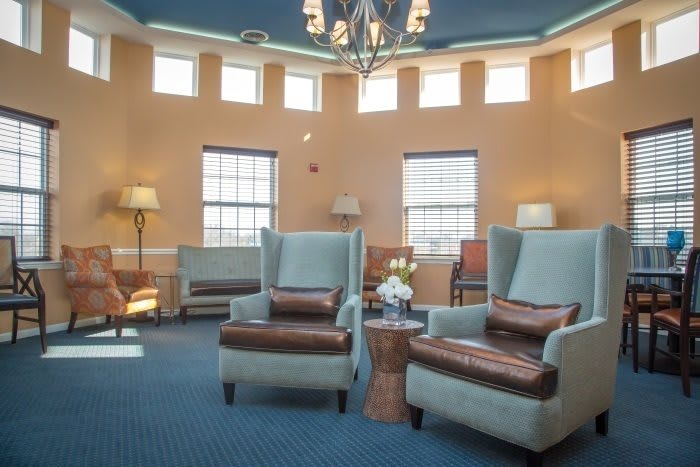 A cozy lounge area with comfortable armchairs and warm lighting.
