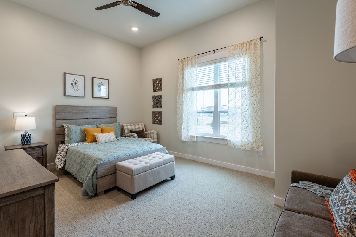 A cozy and minimalistic bedroom with a large window and stylish decor.